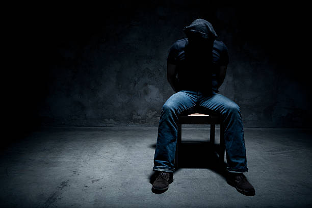 Kidnapped man in a dark room
